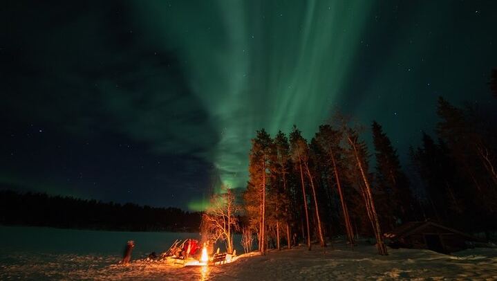 Northern Lights Hunt from a Lappish Cottage in the Forest