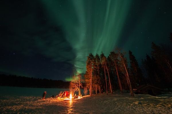 Northern Lights Hunt from a Lappish Cottage in the Forest