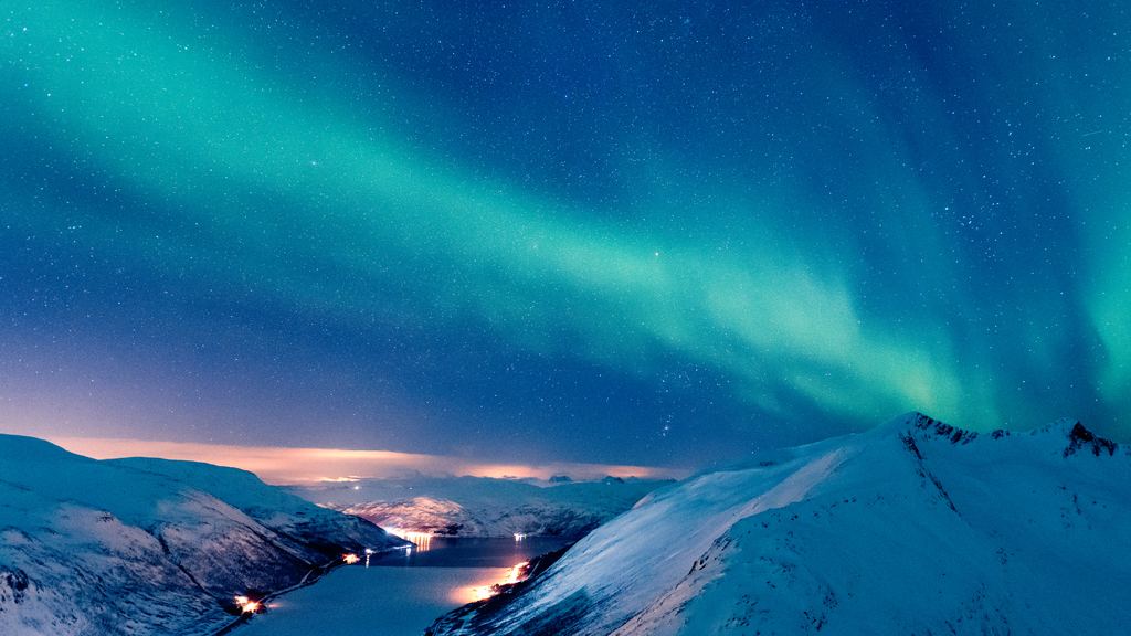 Aurora reflected in the still surface of a lake near Tromsø